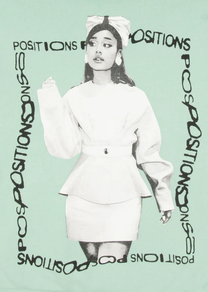 Closeup detail of Ariana Grande Positions portrait graphic on mint hoodie with retro album-inspired typography