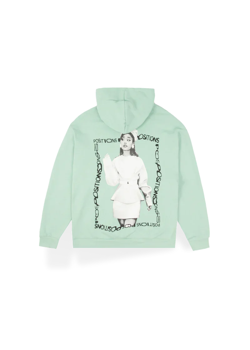 Mint green Ariana Grande Positions hoodie back view with monochrome portrait artwork and circular logo design