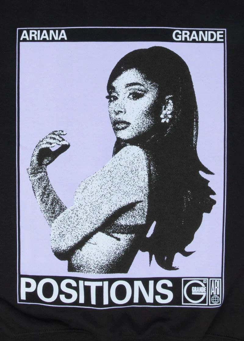 Close-up of Ariana Grande Positions photo graphic on black crewneck with monochrome portrait and retro typography print design