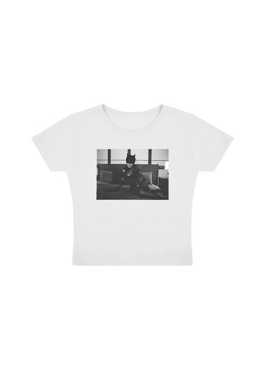 White Ariana Grande TBIM photo baby tee featuring black and white catwoman-inspired graphic with fitted soft cotton style