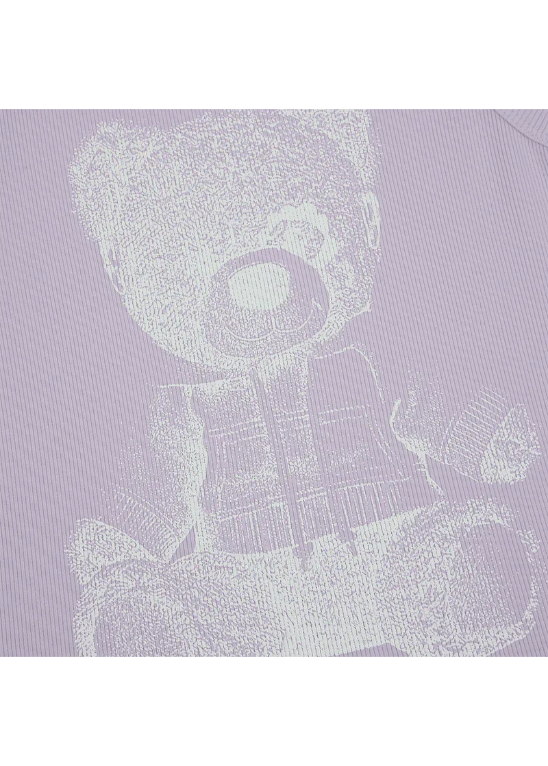 Ariana Grande teddy ribbed tank top close-up featuring reflective bear artwork on lavender fabric