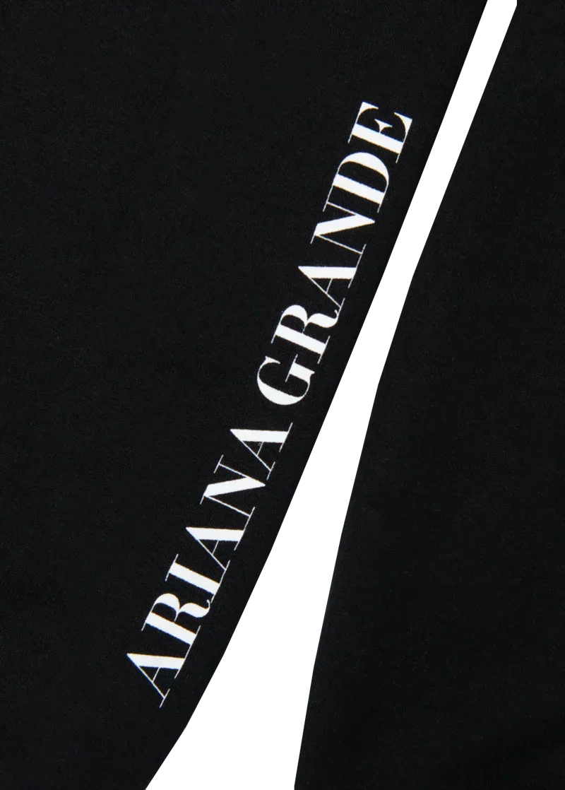 Black Ariana Grande crewneck sleeve detail with vertical white Ariana Grande logo print on cuff sleeve